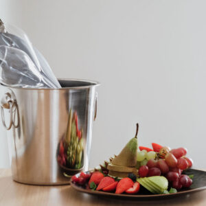 Bottle of sparkling wine and fruit plate